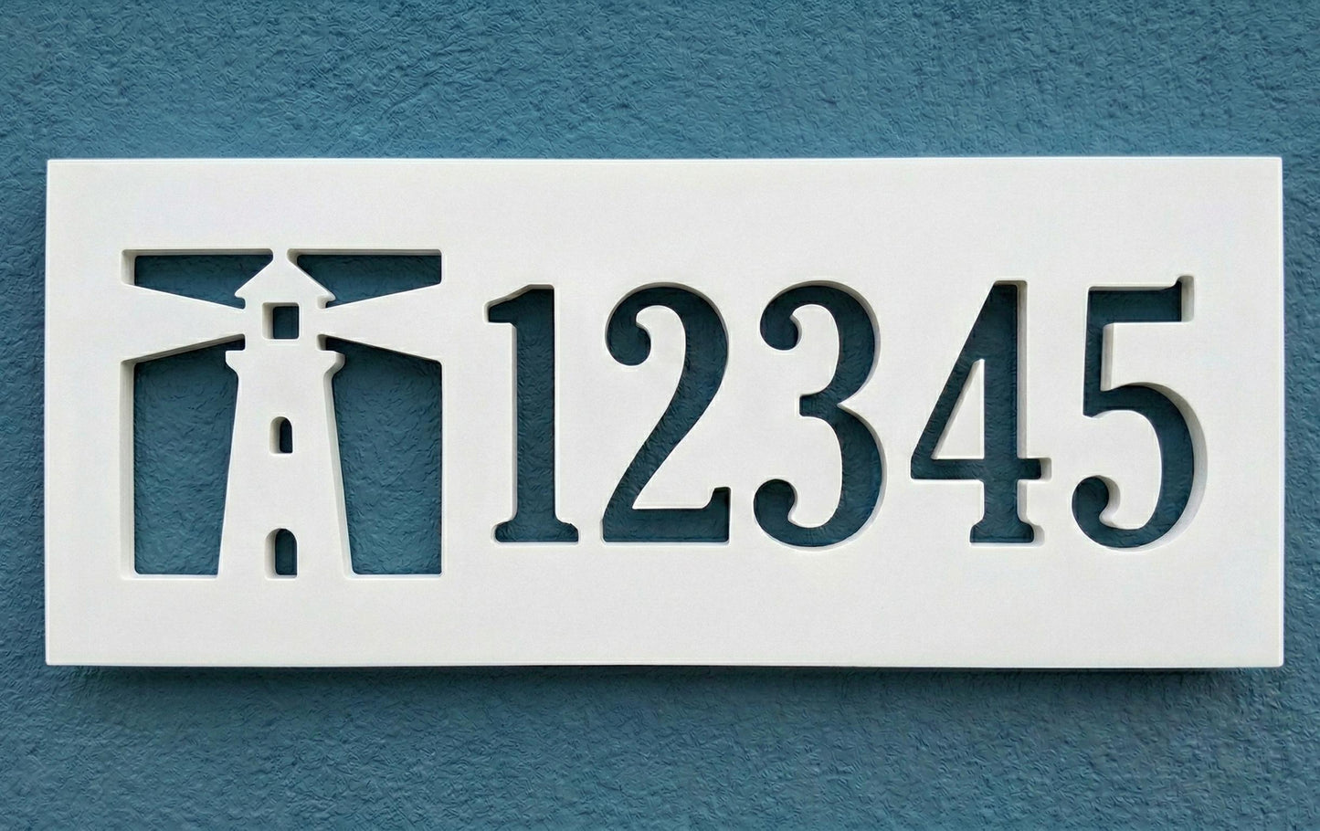 Decorative PVC house number sign with cut-out design on a blue background