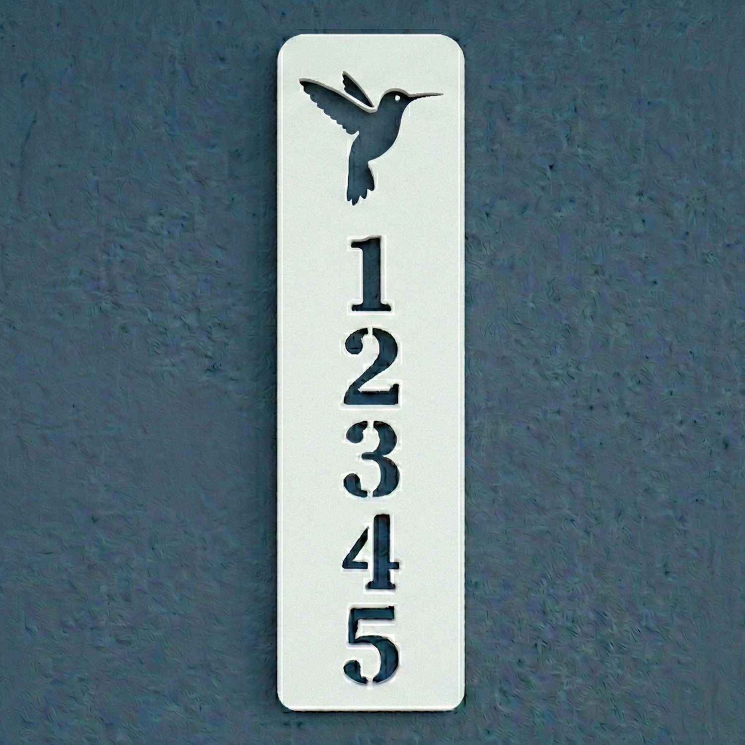 Decorative house number sign with a hummingbird design on a blue background