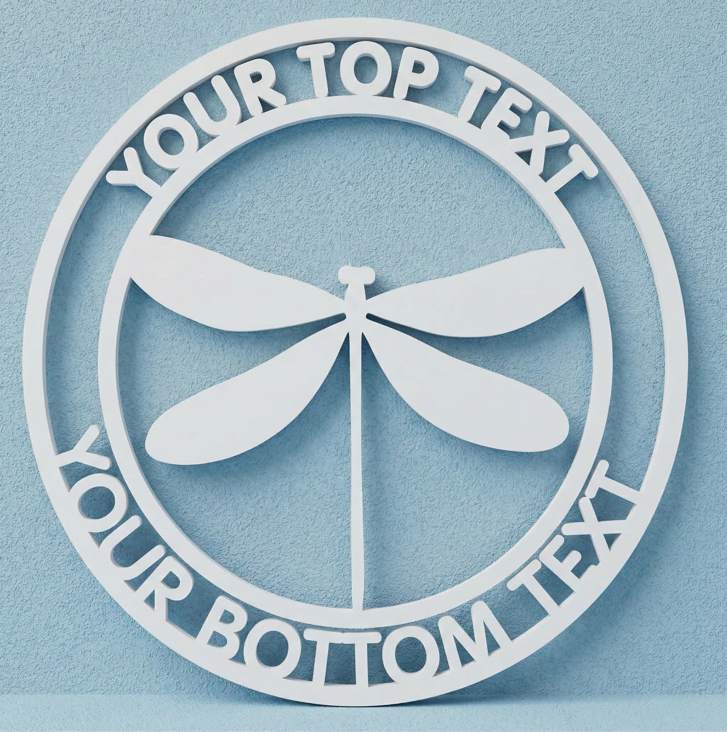 Decorative wall art with a dragonfly design and customizable text on a light blue background