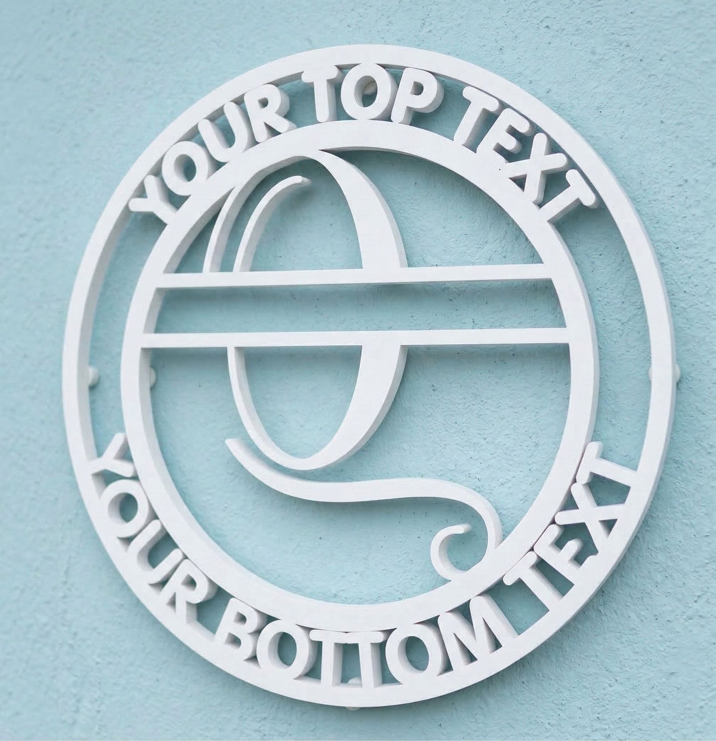 Decorative white PVC wall art with the letter "Q" and customizable text on a light blue background